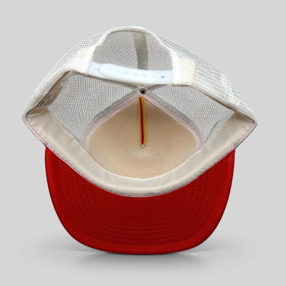 Raree Finds vintage 1980s Domino’s Pizza trucker hat interior view showing white mesh back and red foam brim