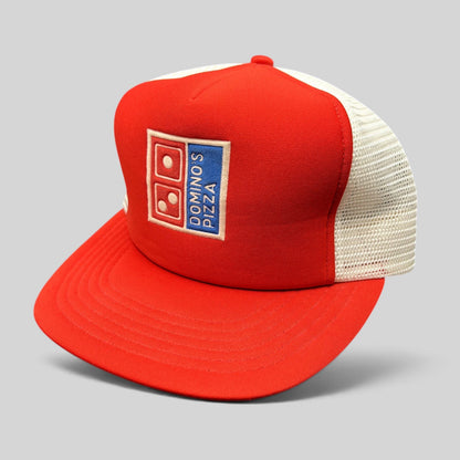 Raree Finds vintage 1980s Domino’s Pizza trucker hat with red foam front, white mesh back, and embroidered logo.