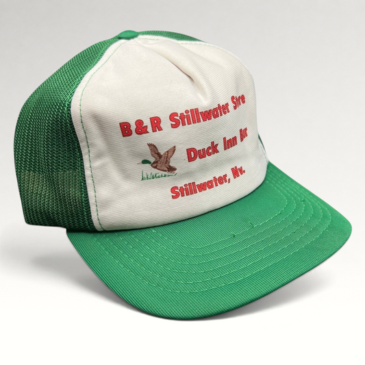 Raree Finds vintage 1980s trucker hat with white foam front, green mesh back, and Duck Inn Bar embroidery