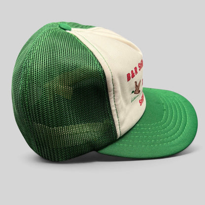 Raree Finds vintage trucker hat with green mesh back, white foam front, and Duck Inn Bar embroidery on a green brim.