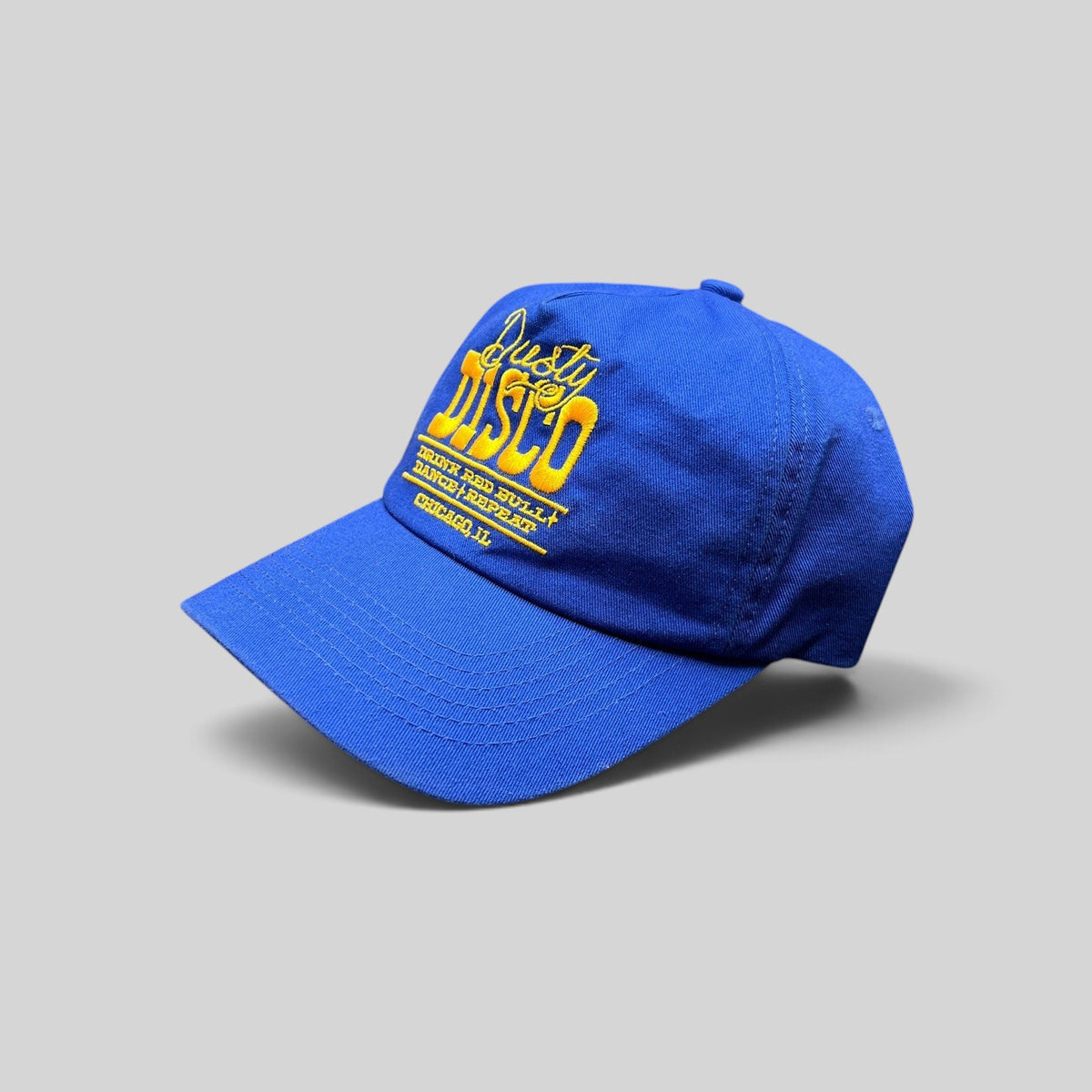 Raree Finds vintage royal blue snapback hat with yellow Dusty Disco Chicago embroidery and adjustable back closure.