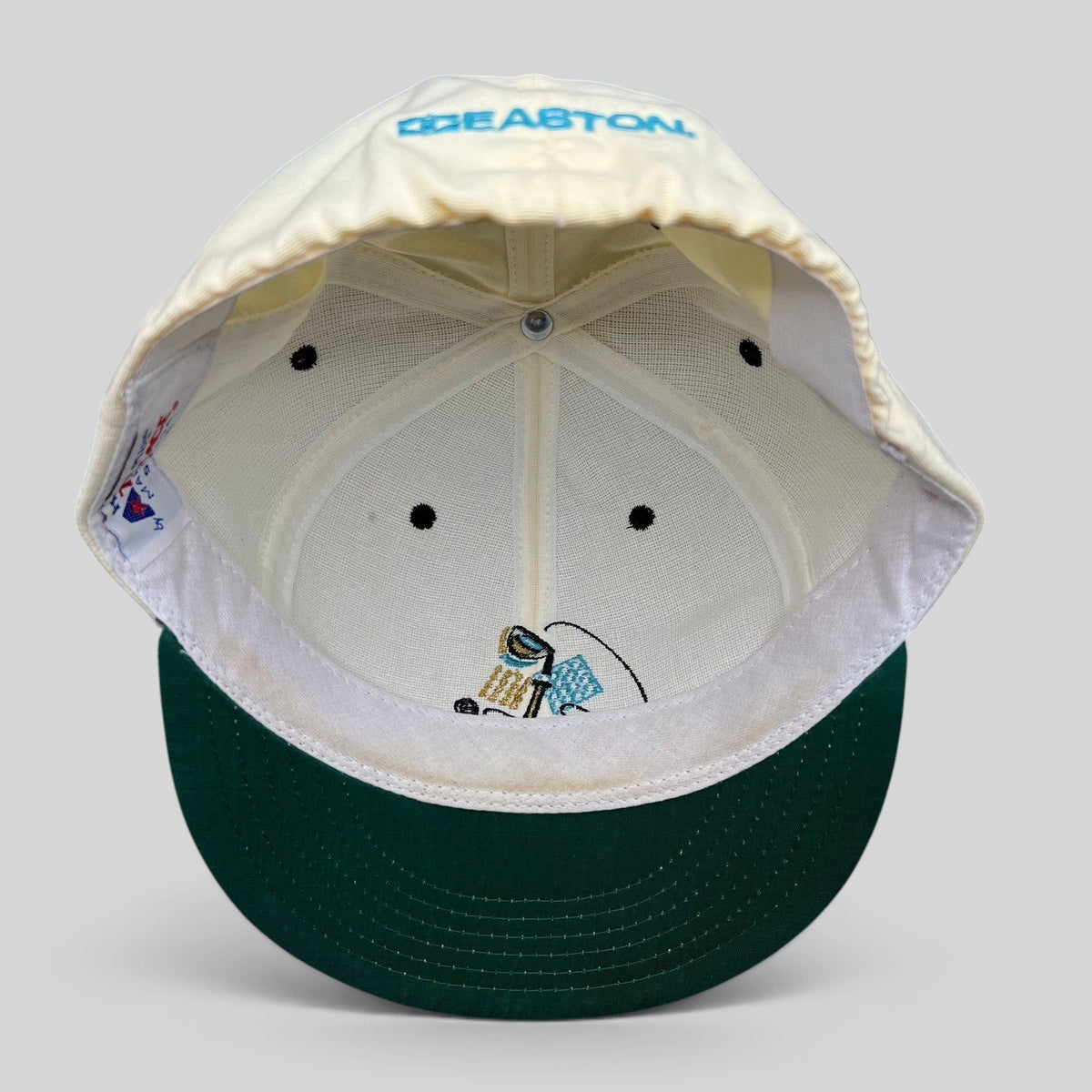 Raree Finds vintage 90s Easton fitted golf hat interior showing white crown, green undervisor, and USA made tag.