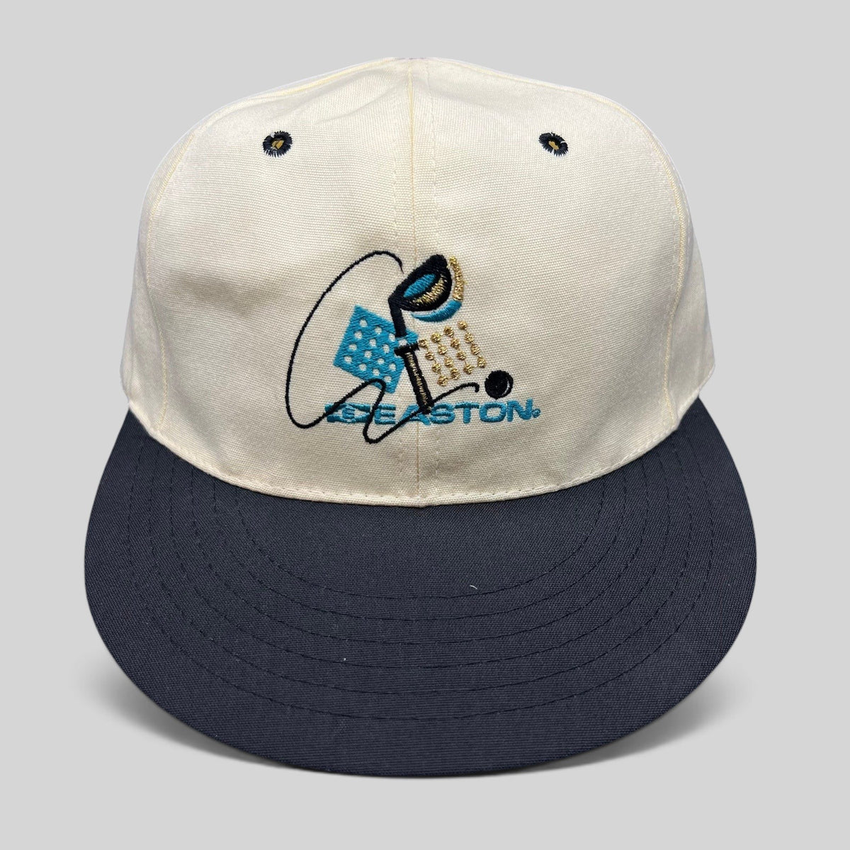 Raree Finds vintage Easton golf hat with white crown, navy brim, and embroidered club graphic on a Pro 98 fitted cap.