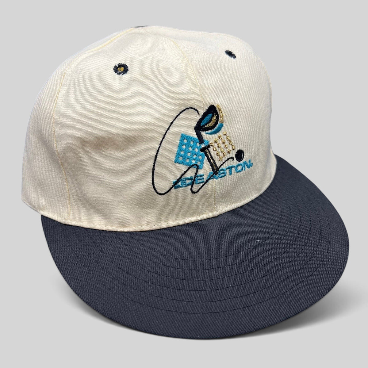Raree Finds vintage 90s Easton fitted golf hat with white crown, navy brim, and embroidered club and ball graphic.