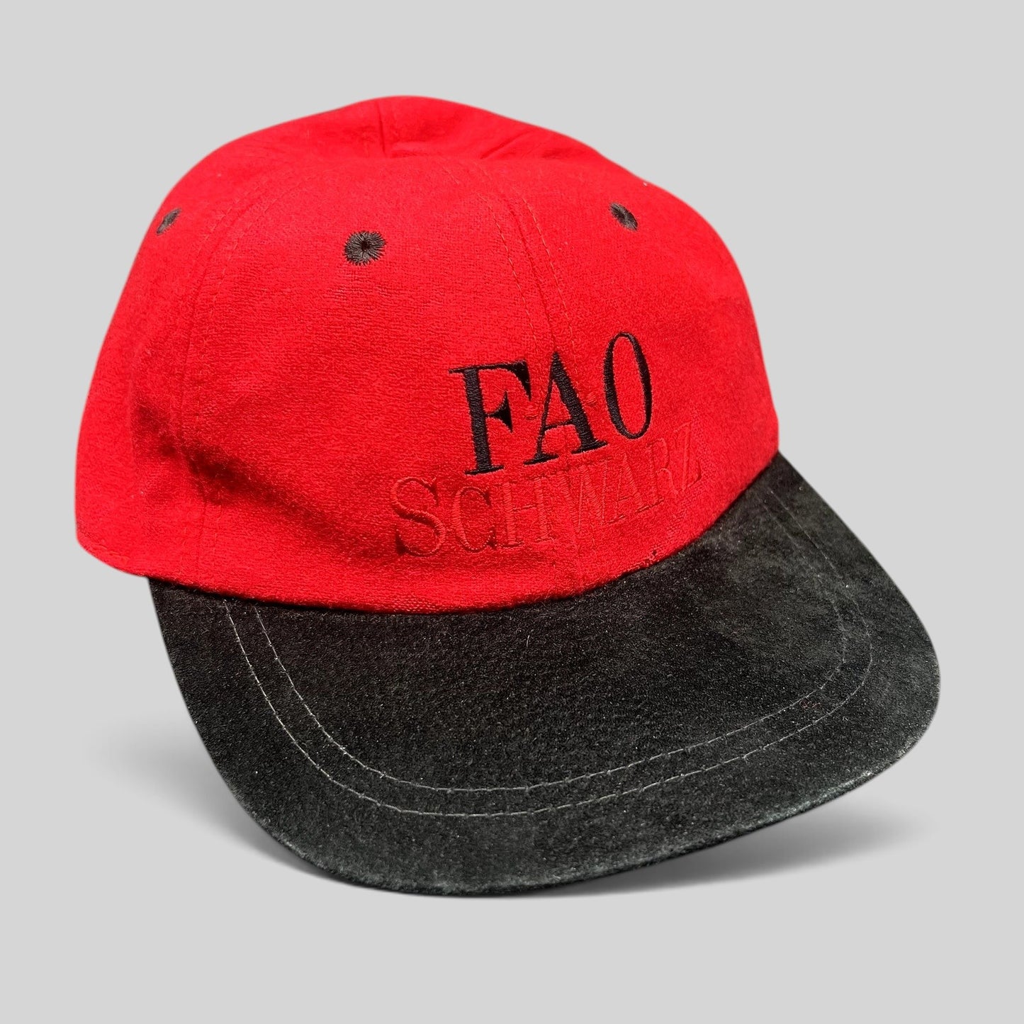Raree Finds vintage FAO Schwarz youth strapback hat in red wool with a black brim and embroidered logo