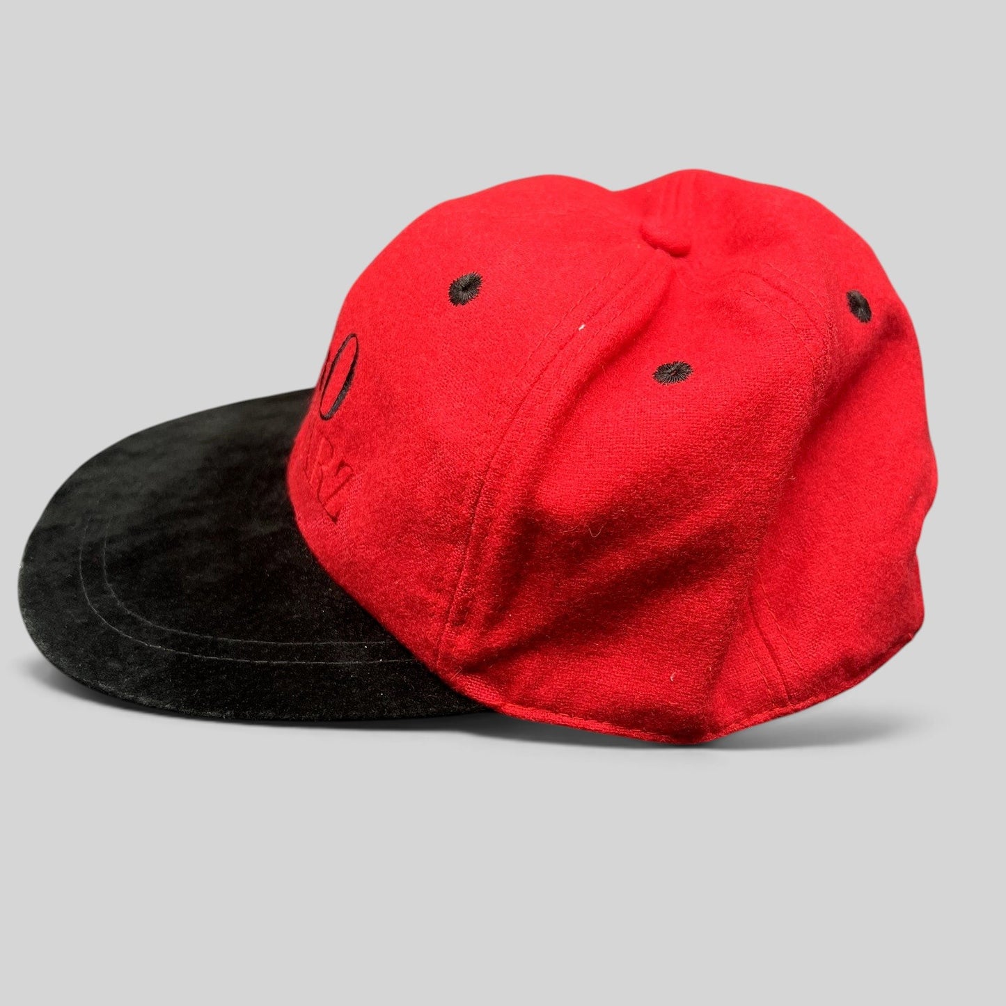 Raree Finds vintage FAO Schwarz youth strapback hat in red wool with a black brim and embroidered logo detail.