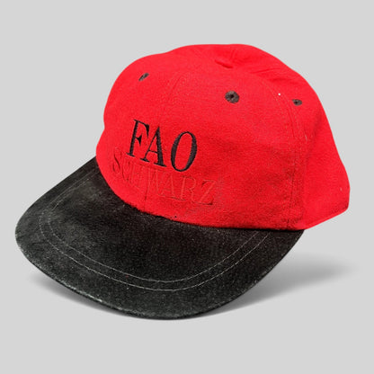 Raree Finds vintage FAO Schwarz youth strapback hat in red wool with a black brim and embroidered logo