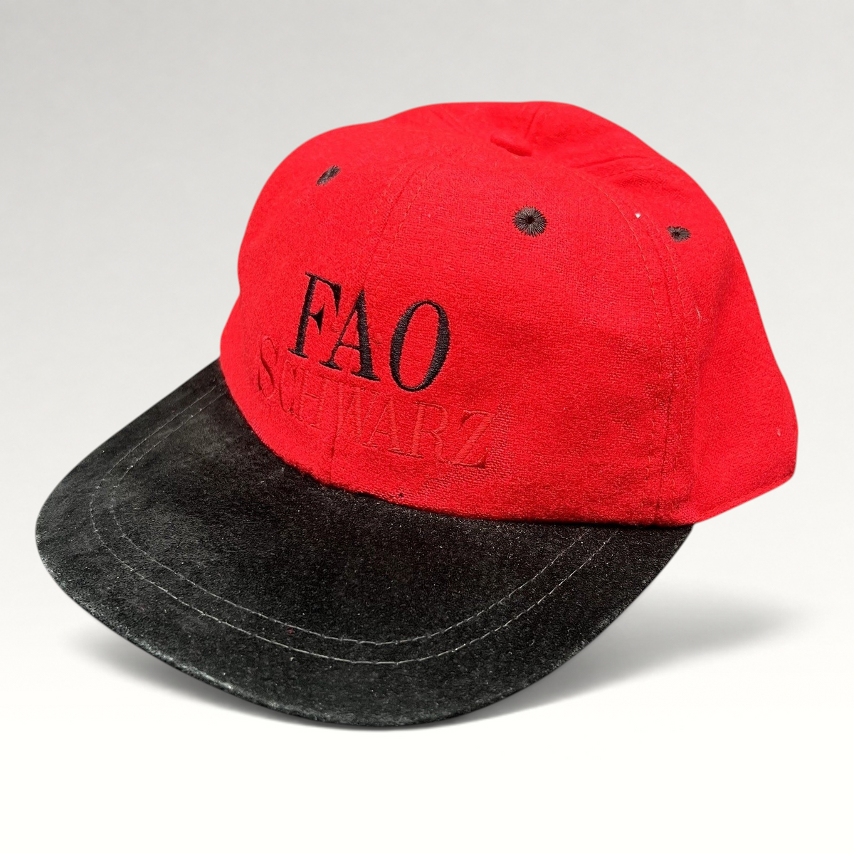 Raree Finds vintage FAO Schwarz youth strapback hat in red wool with a black brim and embroidered logo