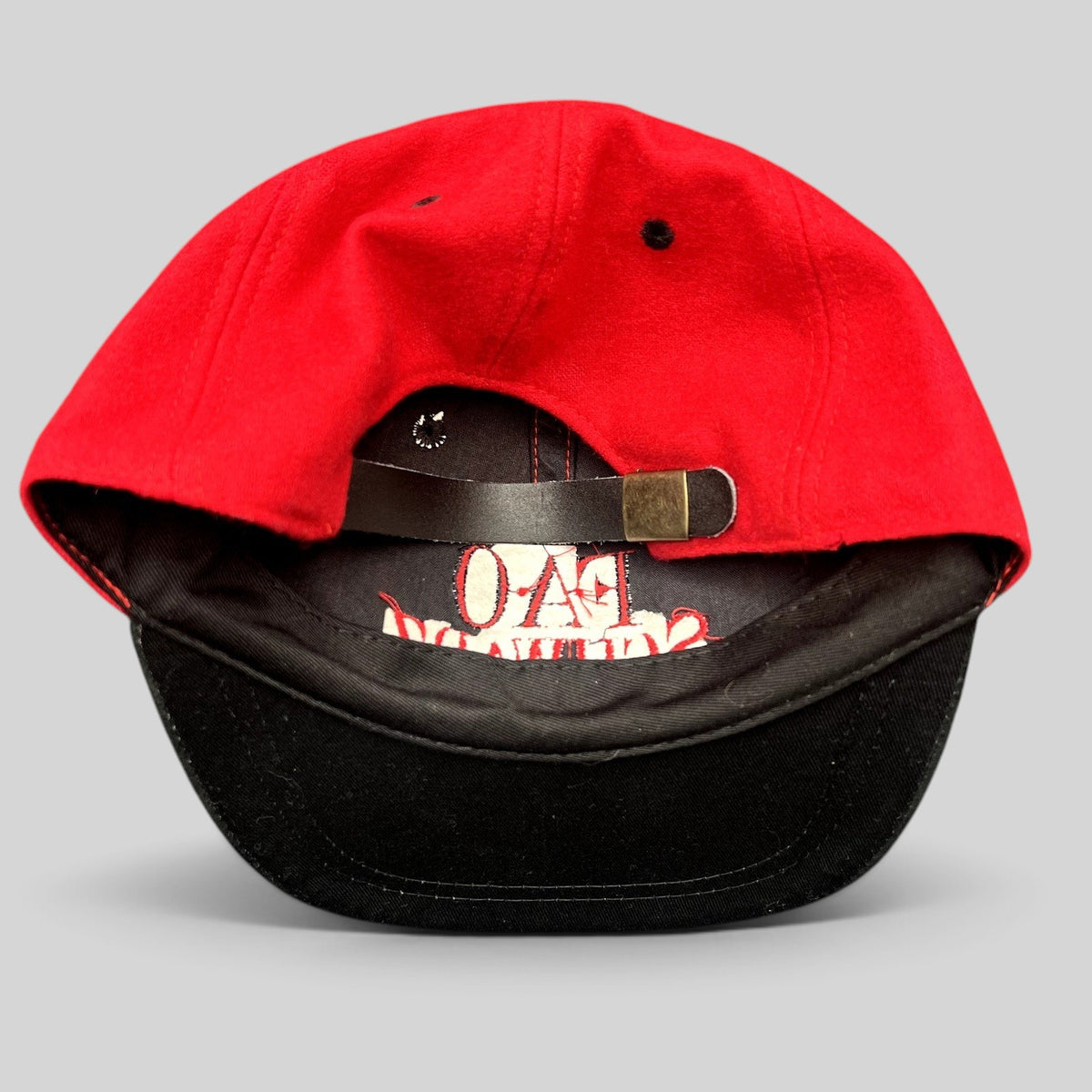 Raree Finds vintage FAO Schwarz youth wool strapback hat in red and black with an adjustable leather strap