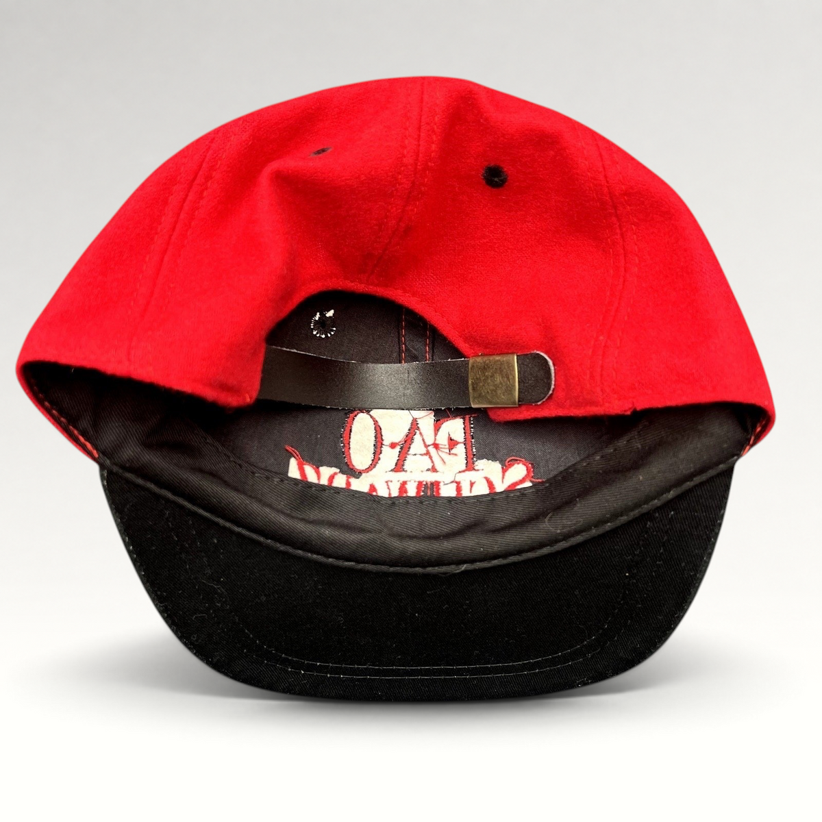 Raree Finds vintage FAO Schwarz youth wool strapback hat in red and black with an adjustable leather strap