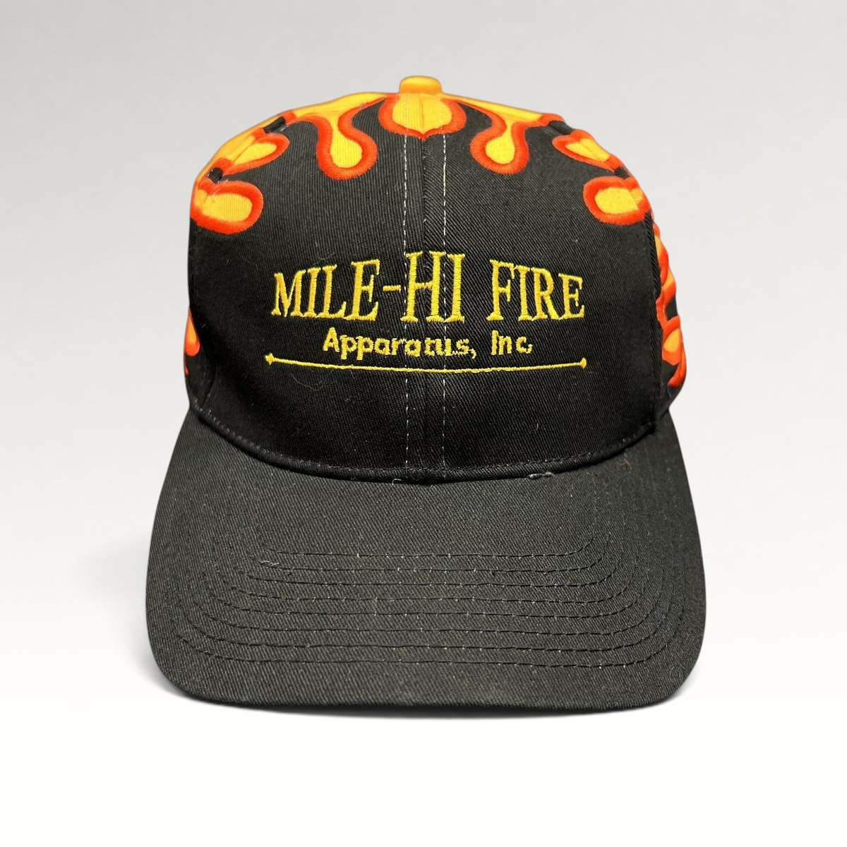 Raree Finds vintage Mile-Hi Fire Apparatus strapback hat with black front, yellow crown, and red flame embroidery.