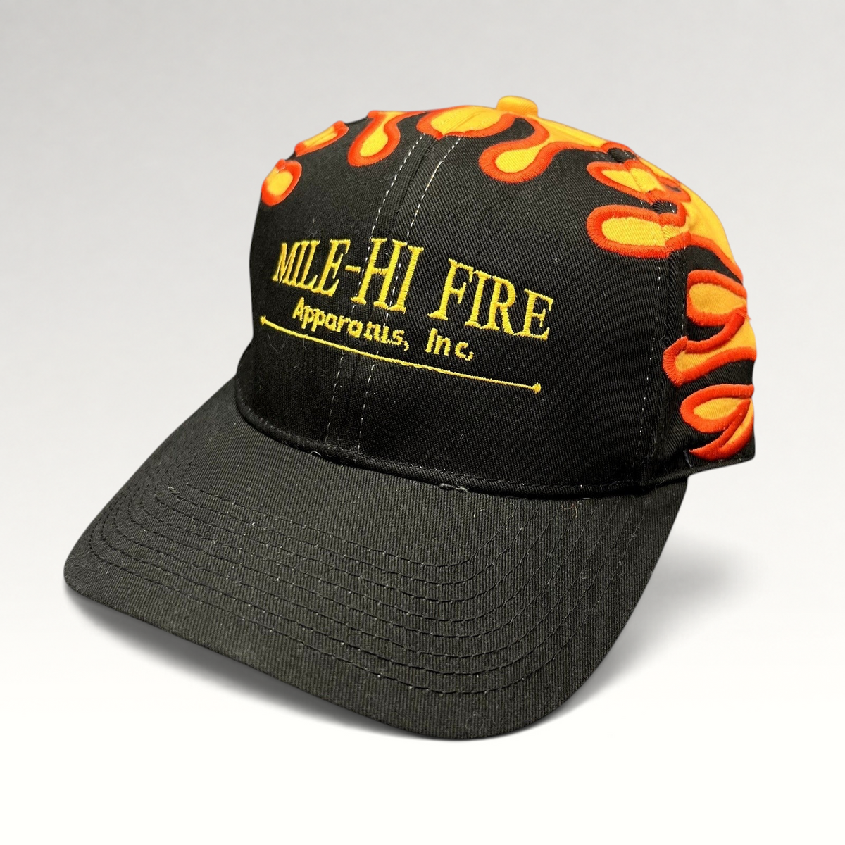 Raree Finds vintage Mile-Hi Fire Apparatus strapback hat with black cotton fabric and embroidered orange flame design.