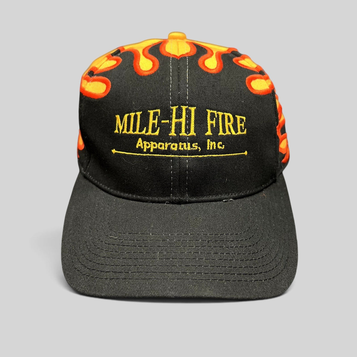 Raree Finds vintage Mile-Hi Fire Apparatus strapback hat with black brim and yellow crown featuring red flame embroidery