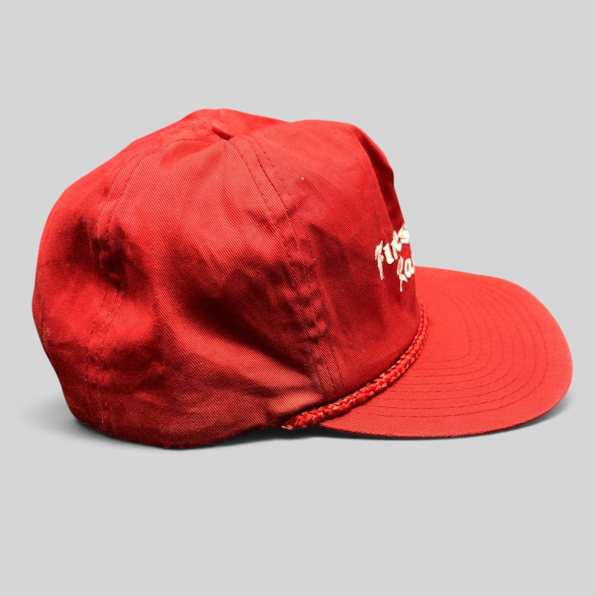 Raree Finds vintage red Firestone Racing snapback hat with white embroidered logo and braided rope brim detail.