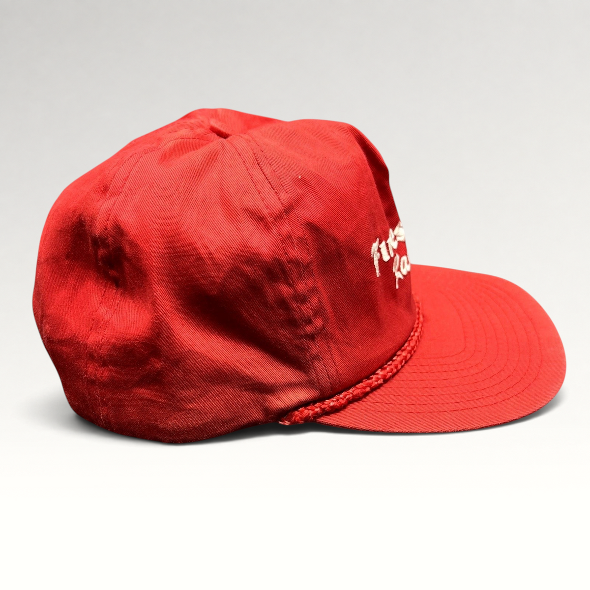Raree Finds vintage red Firestone Racing snapback hat with white embroidered logo and braided rope brim detail.