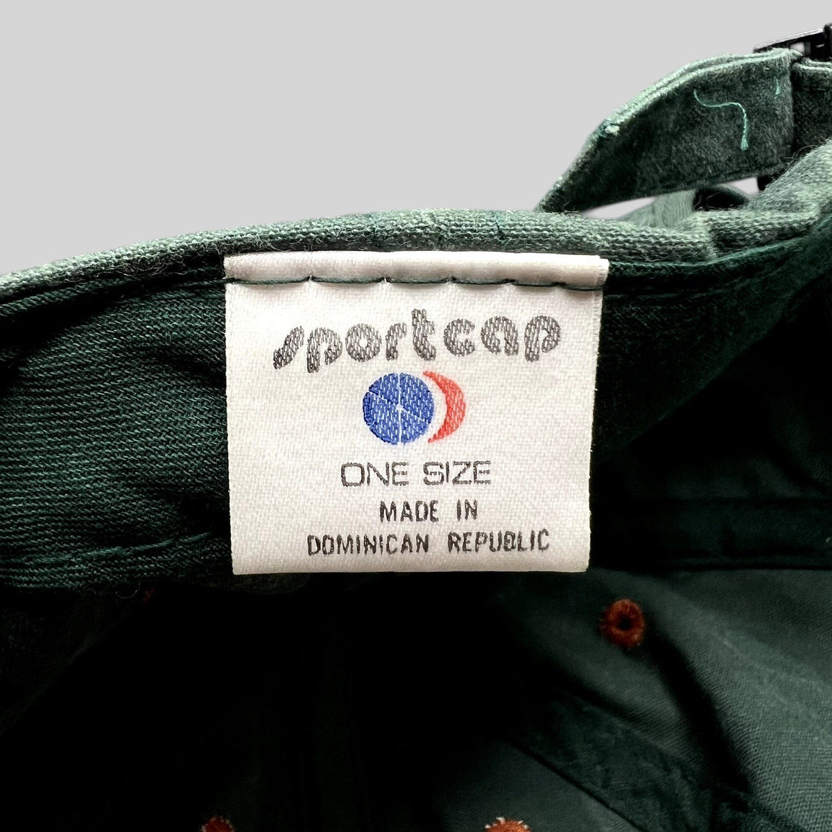 Raree Finds vintage green strapback fishing hat interior label showing Sportcap branding and origin details