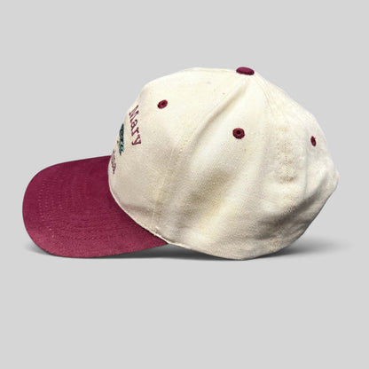 Raree Finds vintage Lake Mary Marina snapback hat with a cream crown, burgundy bill, and fishing fly lure embroidery.