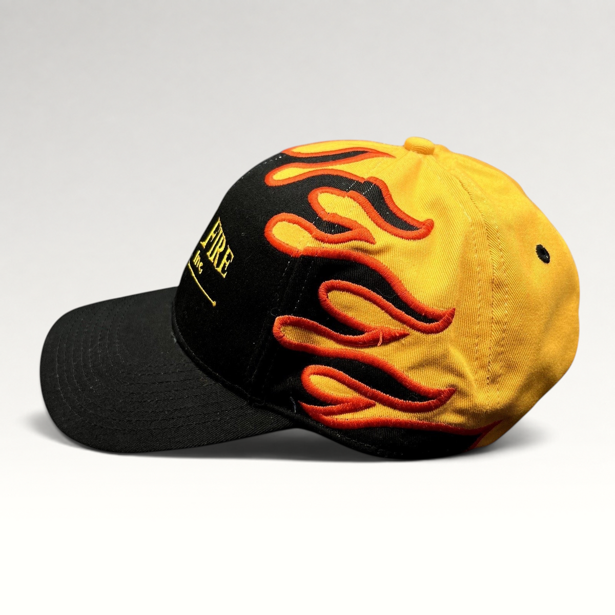 Raree Finds vintage Mile-Hi Fire Apparatus strapback hat with black brim and yellow crown featuring red flame embroidery
