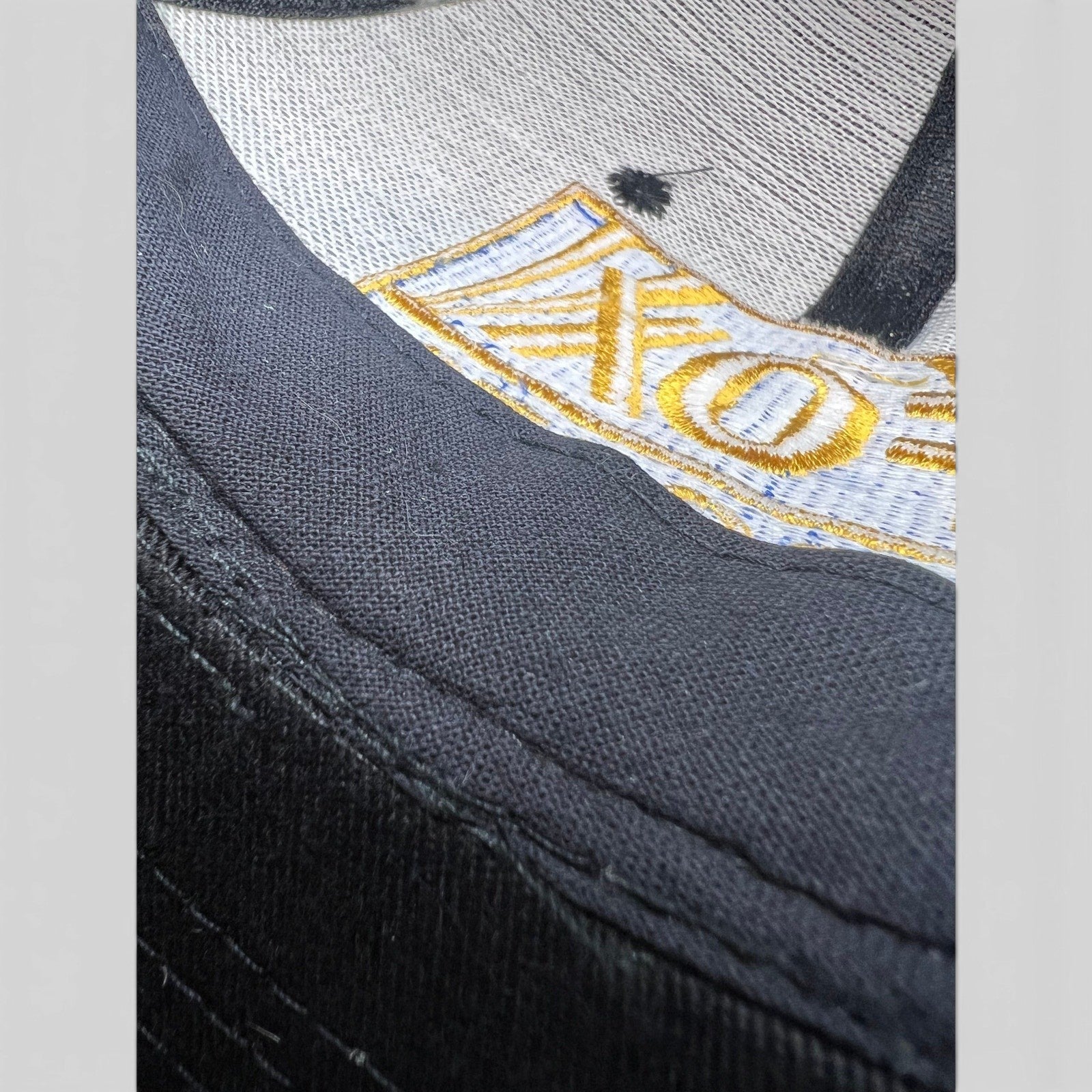 Raree Finds vintage 90s FOX Sports snapback hat featuring detailed gold and blue embroidery on black cotton twill