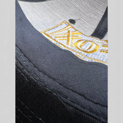 Raree Finds vintage 90s FOX Sports snapback hat featuring detailed gold and blue embroidery on black cotton twill