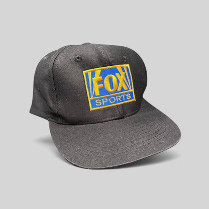 Raree Finds vintage 90s black cotton snapback hat featuring an embroidered gold and royal blue FOX Sports logo