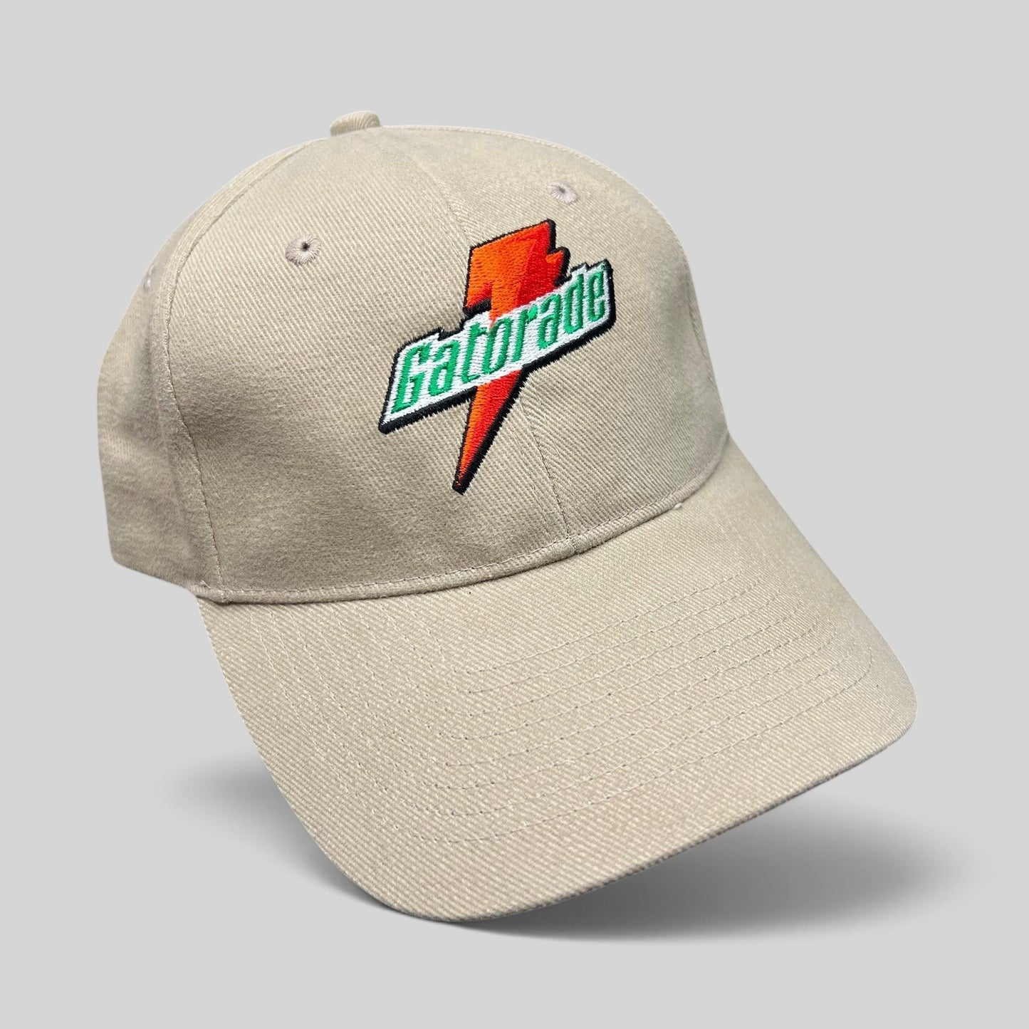 Raree Finds vintage beige cotton strapback hat featuring an embroidered orange and green Gatorade lightning logo.
