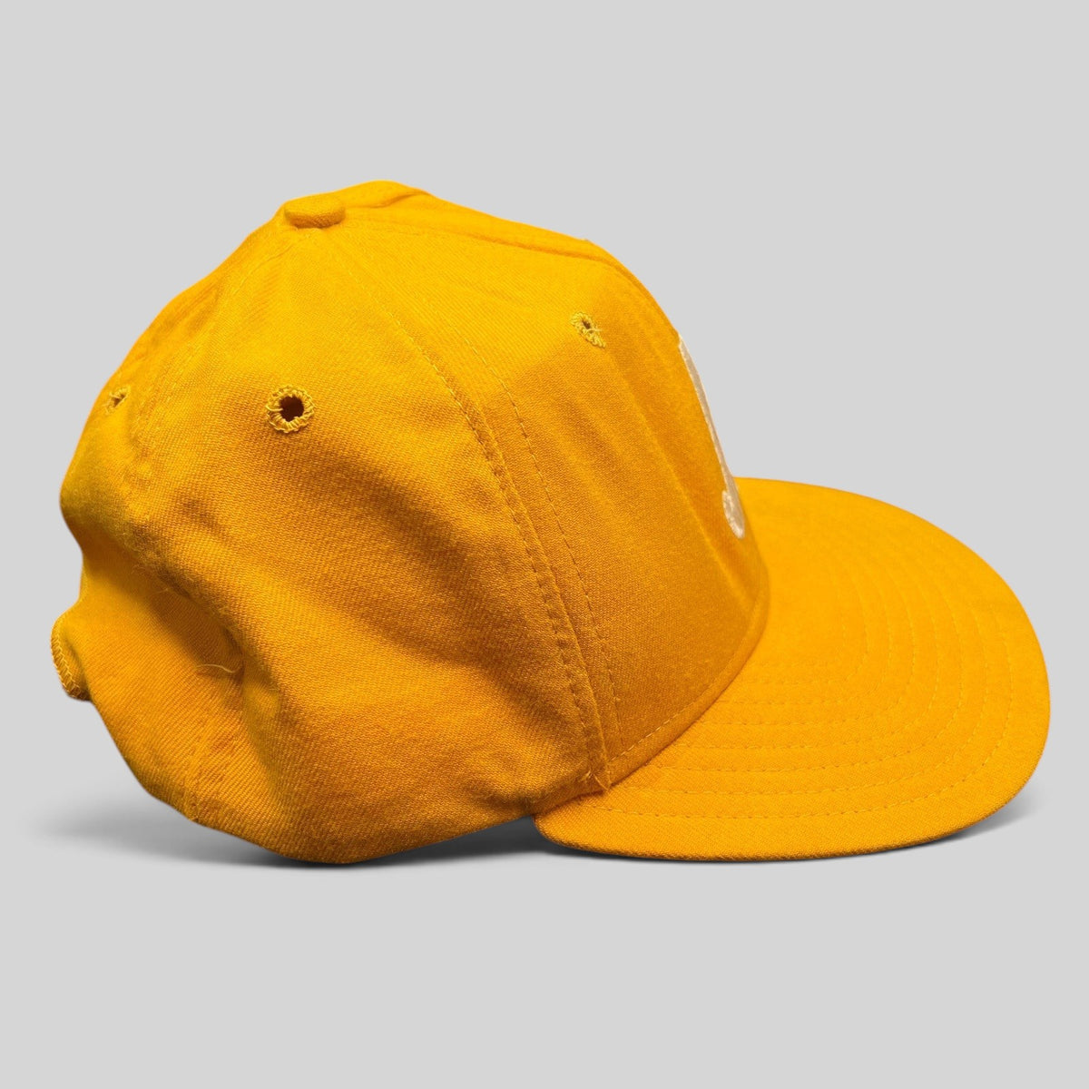 Raree Finds vintage New Era Pro Model gold snapback hat with embroidered A and classic Dupont visor side view