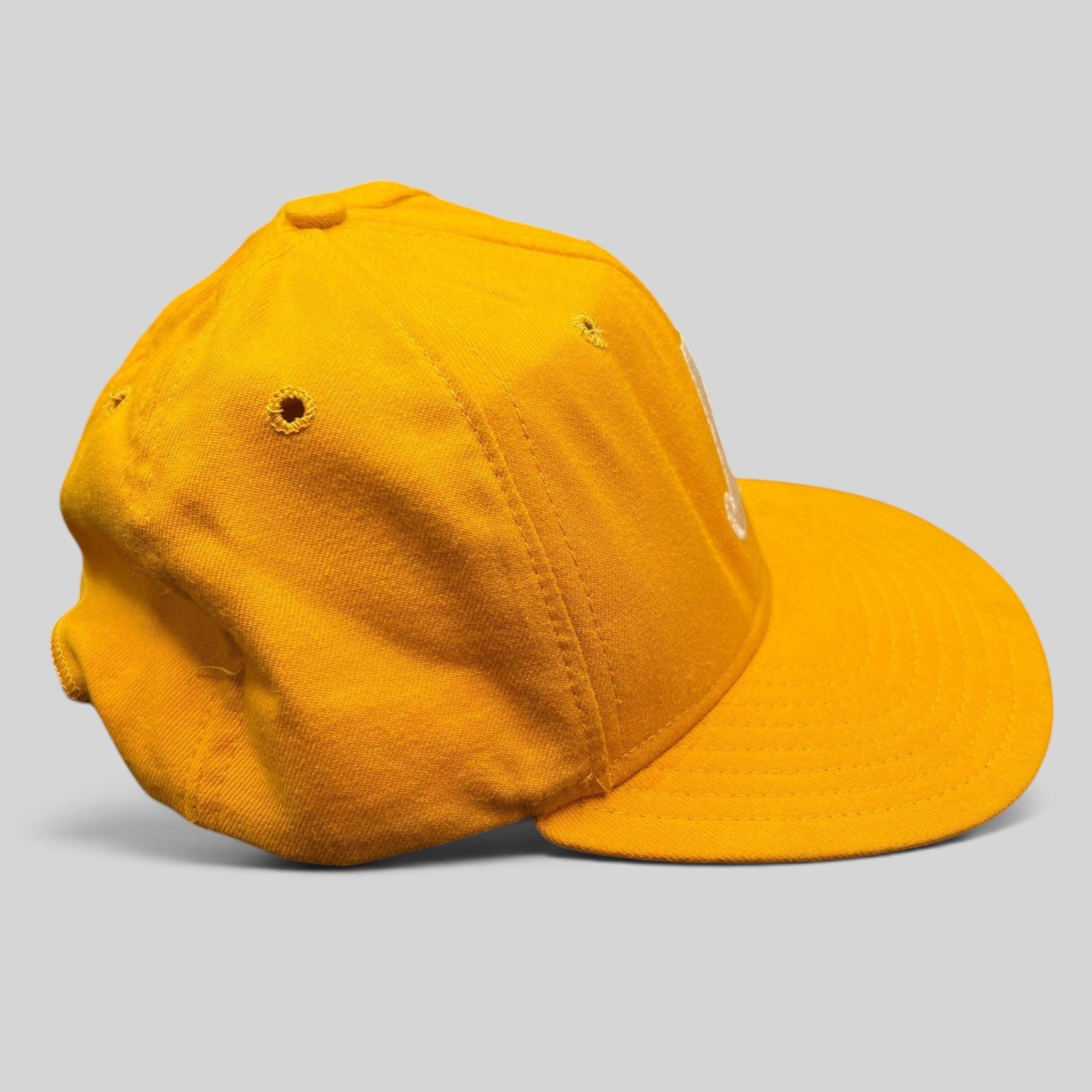Raree Finds vintage New Era Pro Model gold snapback hat with embroidered A and classic Dupont visor side view