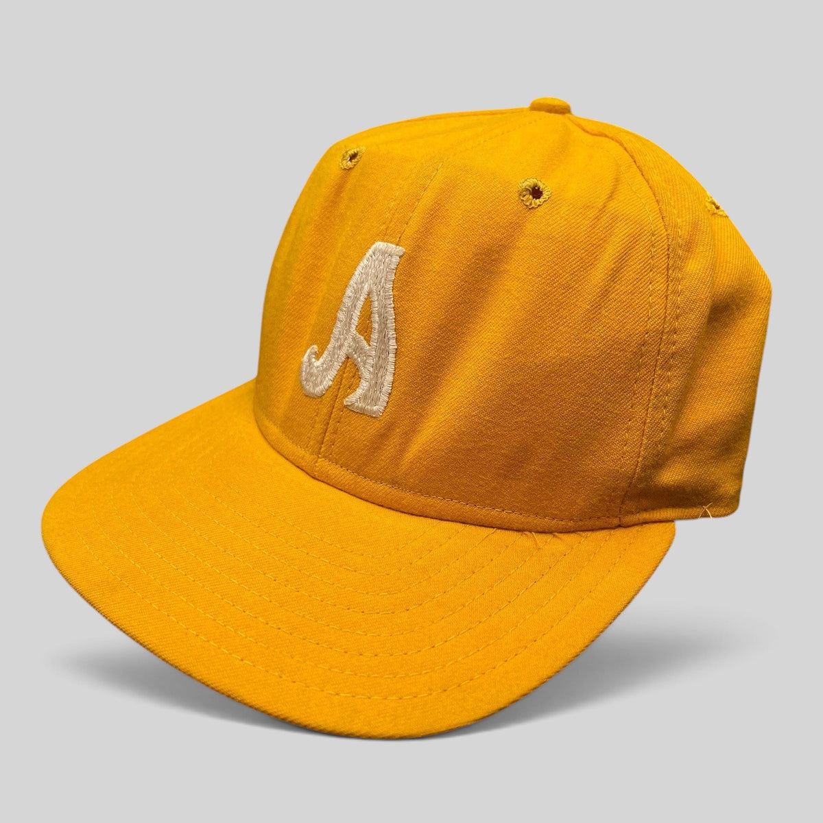 Raree Finds vintage New Era Pro Model gold snapback hat with white embroidered A and classic Dupont visor construction