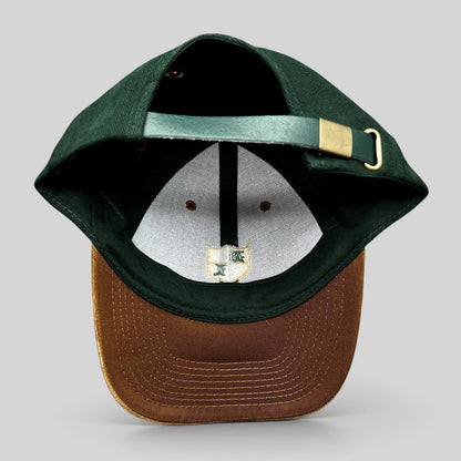 Raree Finds vintage Desert Lake golf hat with forest green crown, tan suede-style brim, and leather strapback closure.