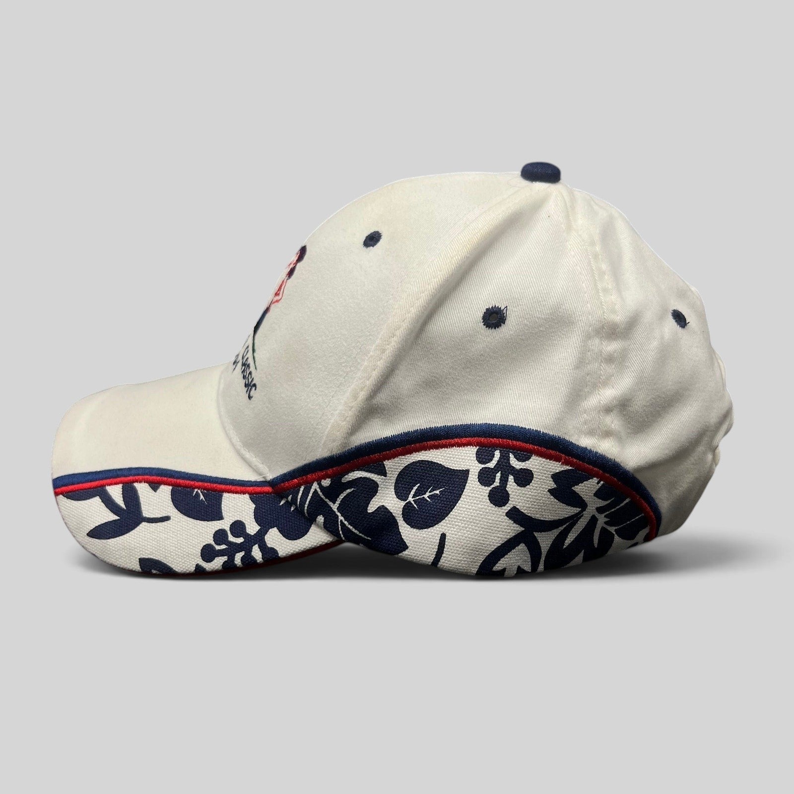 Raree Finds 2004 Desperado Golf Classic white cotton strapback hat with navy floral side panels and red trim