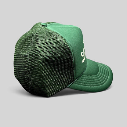 Raree Finds vintage green lemonade mesh trucker hat with white script logo, foam front, and braided rope detail.