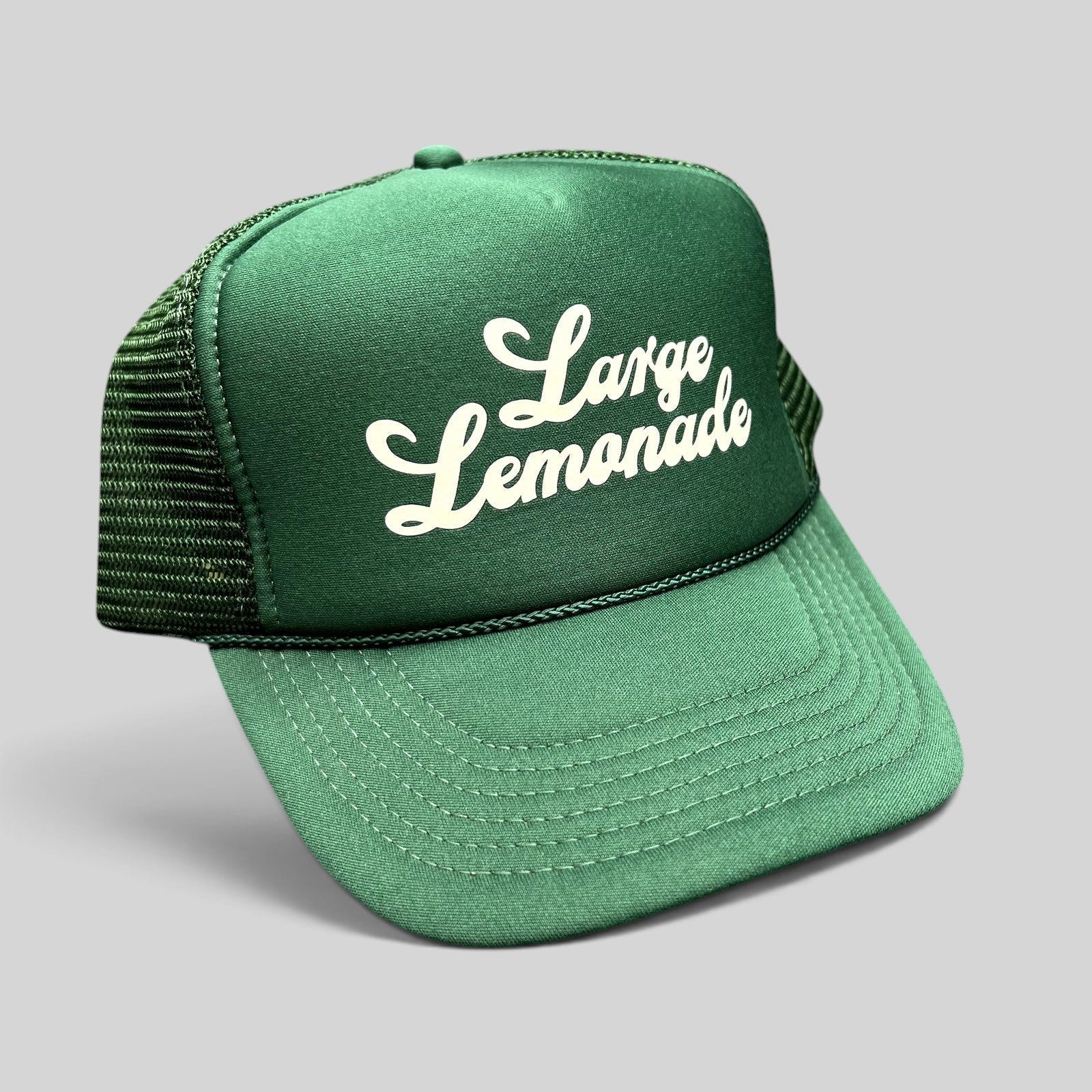 Raree Finds vintage green mesh trucker hat with white Large Lemonade script logo and braided rope detail on the brim.