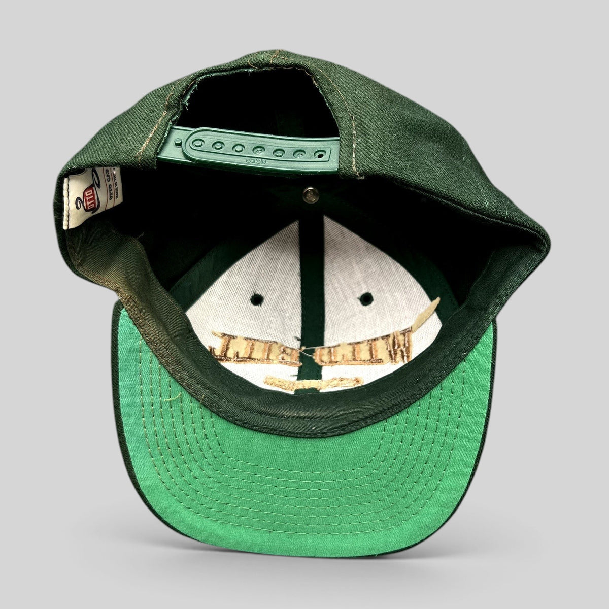 Raree Finds vintage dark green Otto Cap snapback hat with interior view showing structured crown and green undervisor