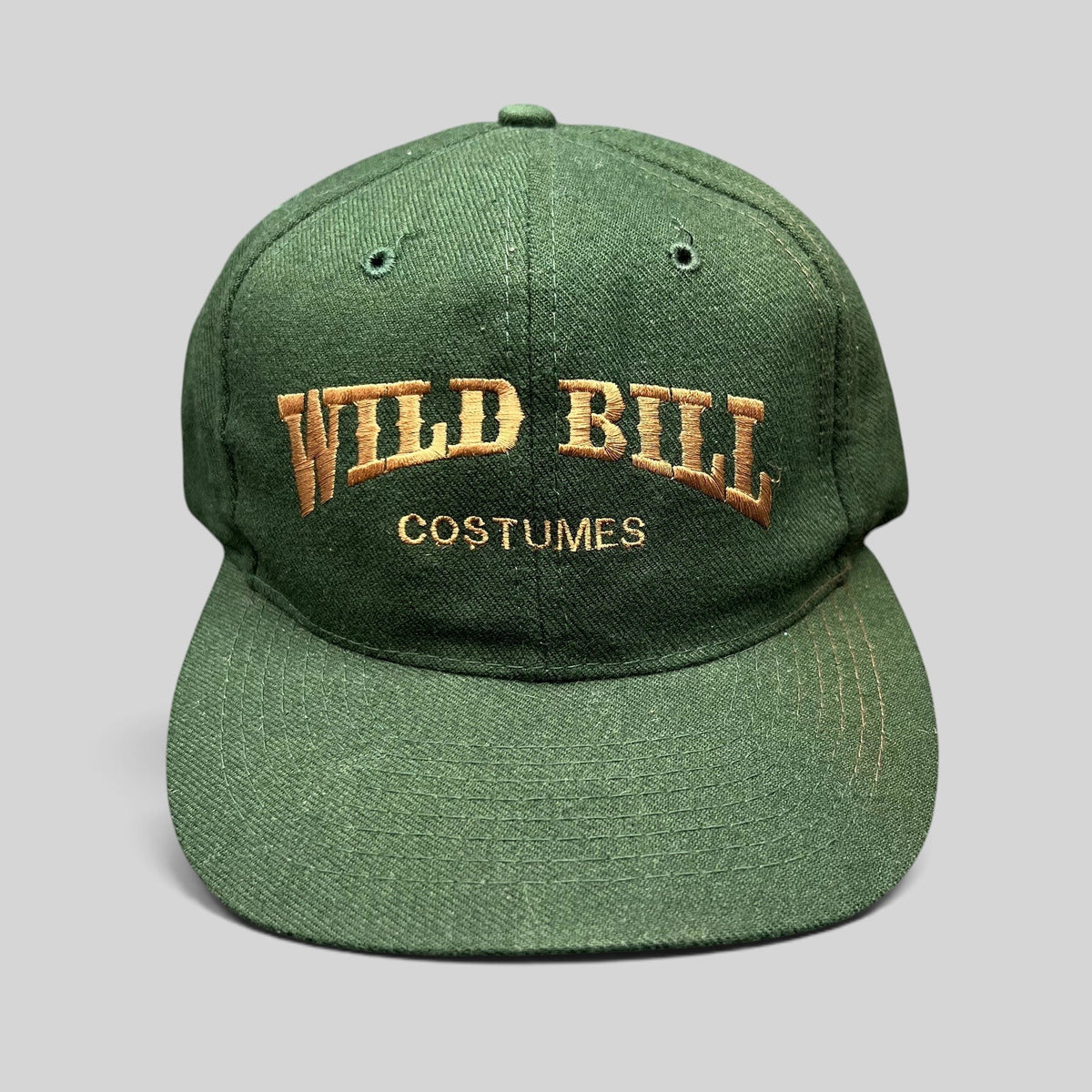 Raree Finds vintage dark green Otto Cap snapback hat with brown Wild Bill Costumes embroidery and flat brim
