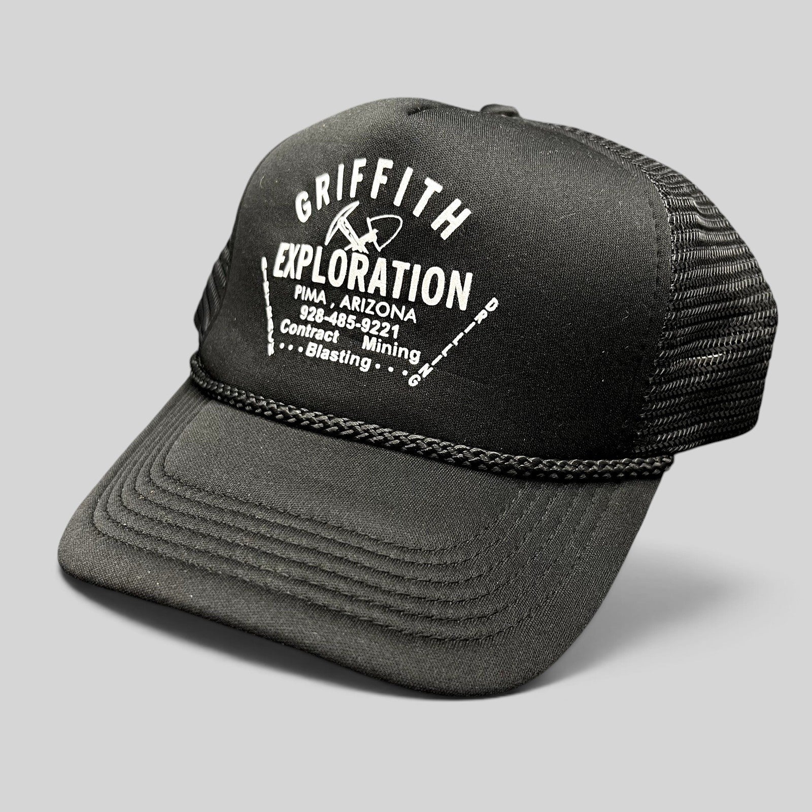 Raree Finds vintage black foam trucker hat with white Griffith Exploration mining graphic and braided brim rope