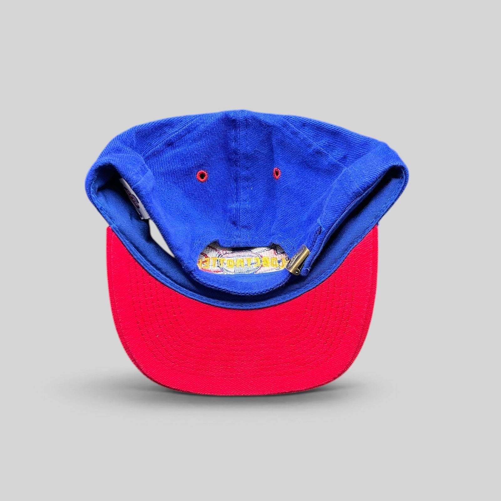 Raree Finds vintage 90s Harlem Globetrotters snapback hat showing the blue crown, red brim, and adjustable strap