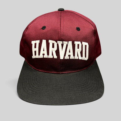 Raree Finds vintage Harvard University snapback hat in crimson and black with white embroidered lettering.