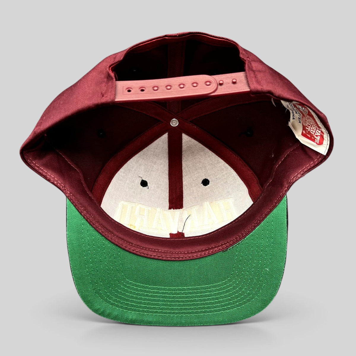 Raree Finds vintage Harvard University snapback hat with crimson crown, green undervisor, and adjustable snap closure.