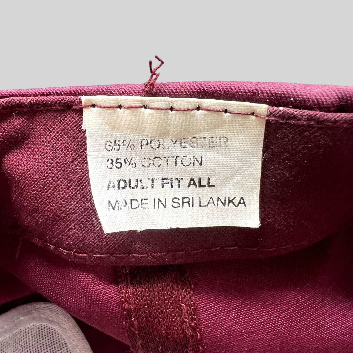 Raree Finds vintage trucker hat interior tag showing 65 percent polyester and 35 percent cotton material composition