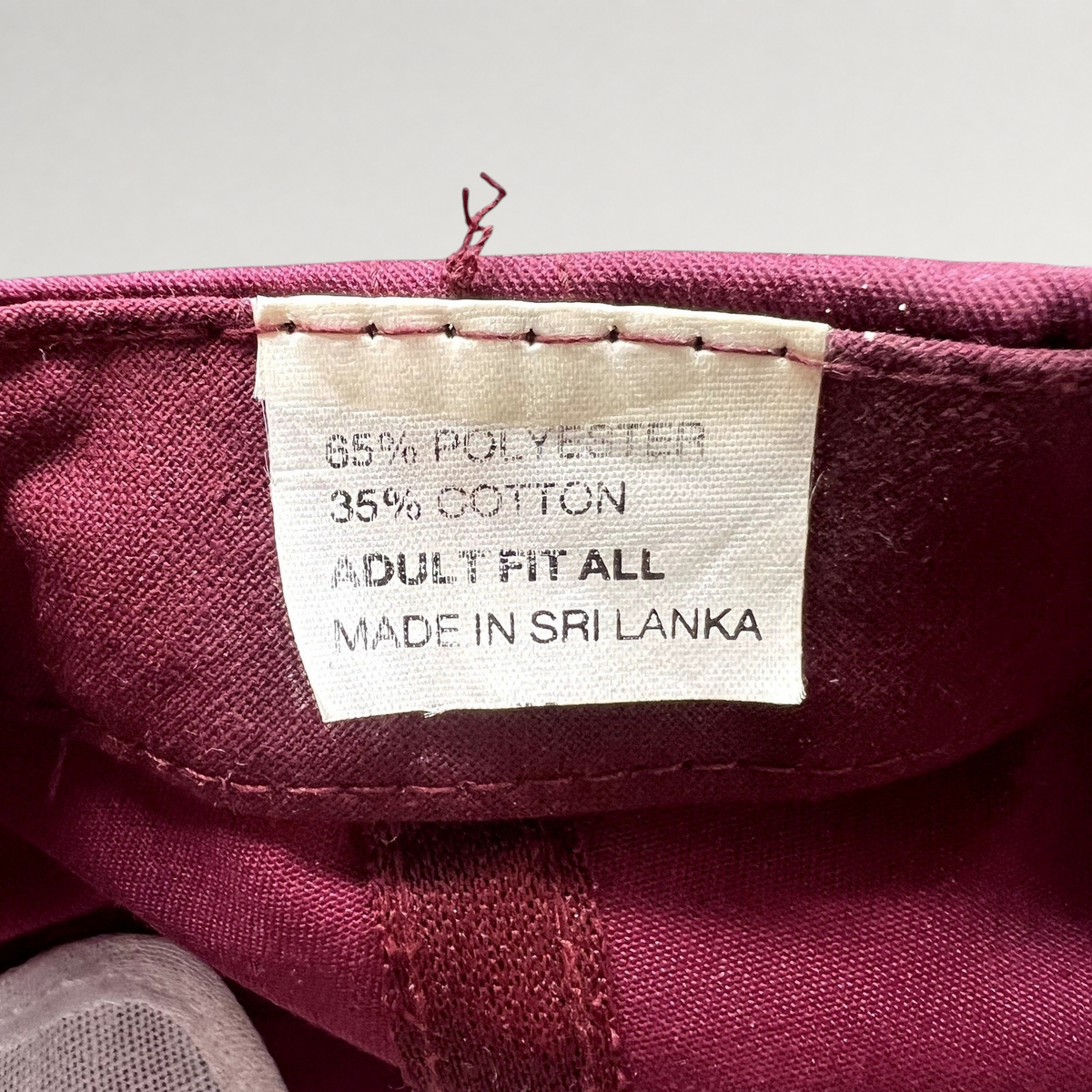 Raree Finds vintage trucker hat interior tag showing 65 percent polyester and 35 percent cotton material composition