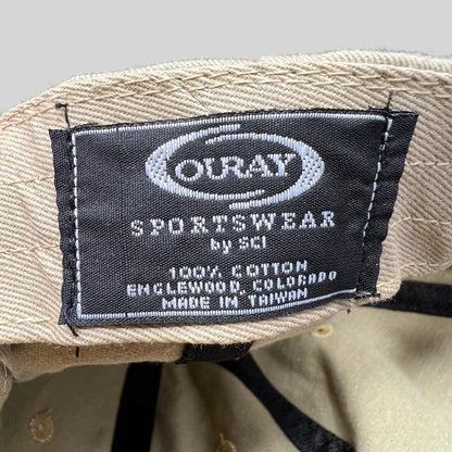 Raree Finds vintage hat interior label showing Ouray Sportswear branding and 100% cotton material details