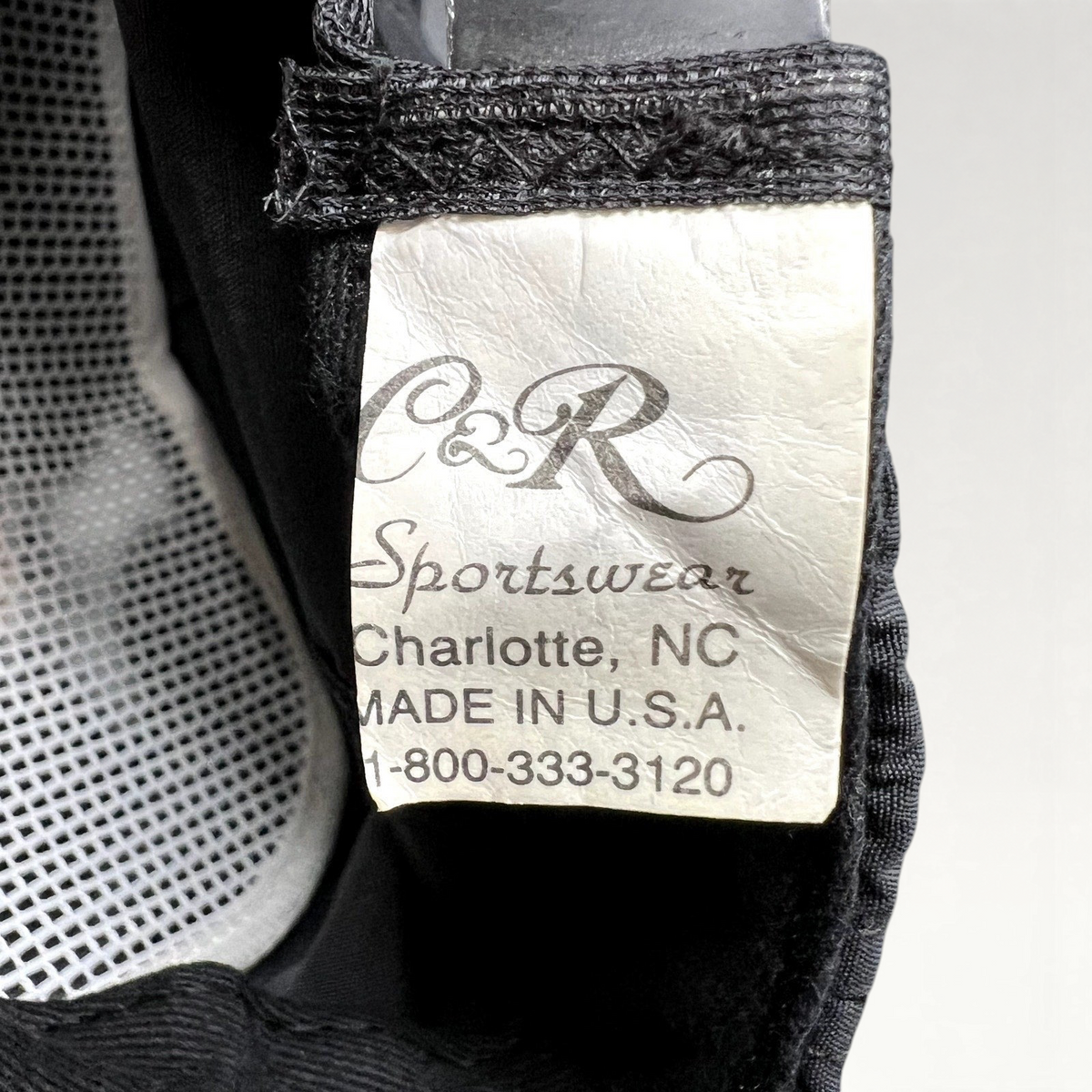 Raree Finds vintage C&R Sportswear tag inside a 90s NBC News snapback hat, showing Made in USA manufacturing details.