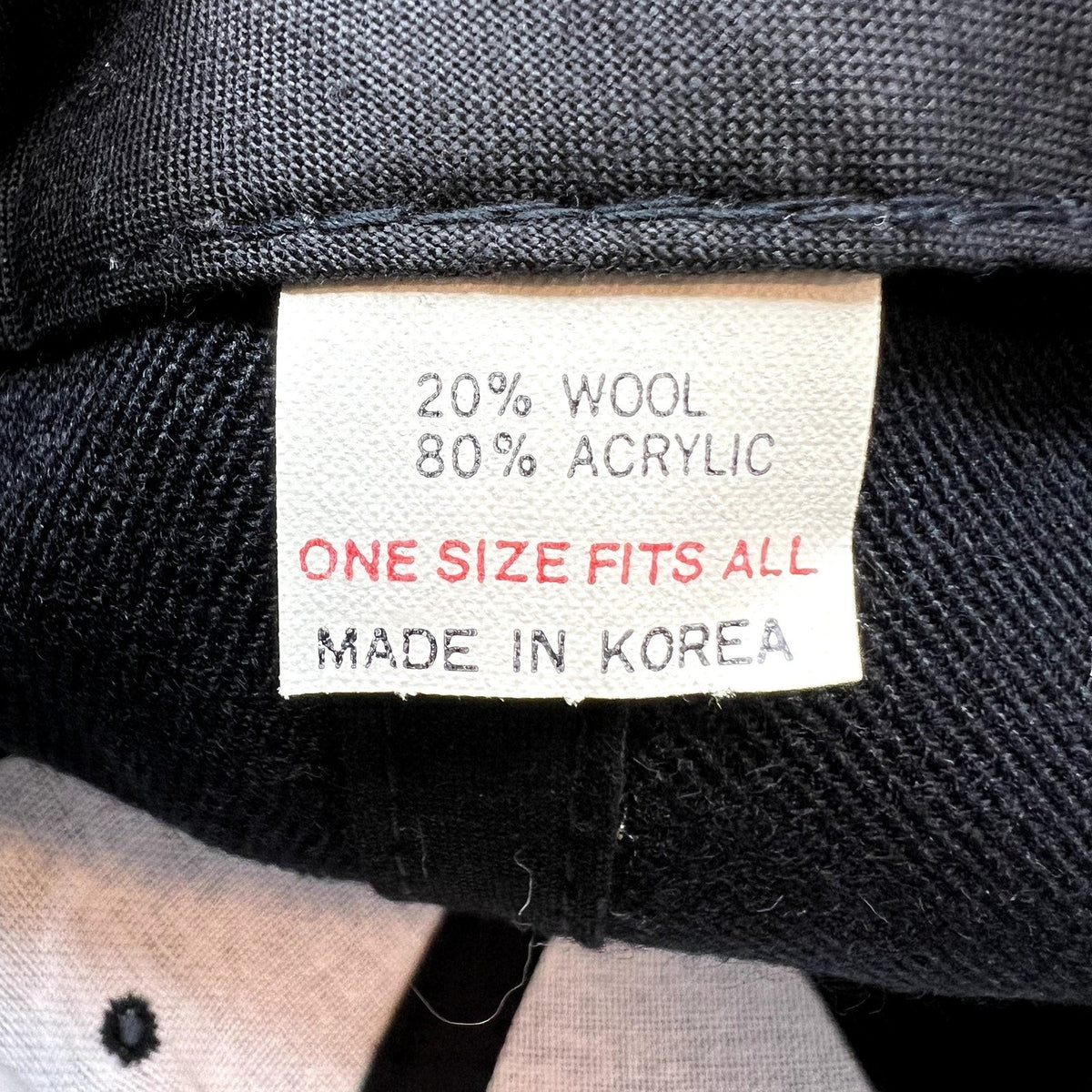 Raree Finds vintage 1996 Rose Bowl hat interior tag showing 20 percent wool and 80 percent acrylic material blend