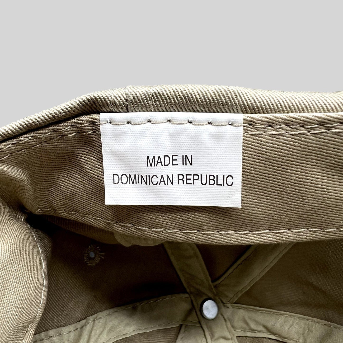 Raree Finds vintage hat interior showing the white fabric tag that reads Made in Dominican Republic on khaki cotton