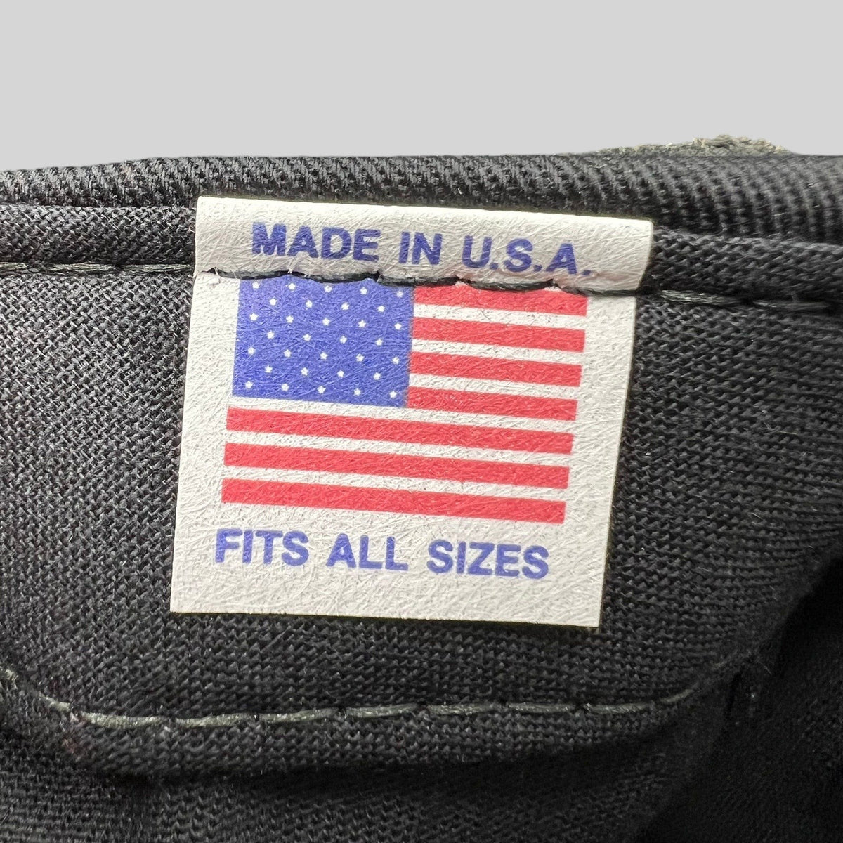 Raree Finds vintage hat interior tag featuring an American flag graphic with Made in U.S.A. and Fits All Sizes text.