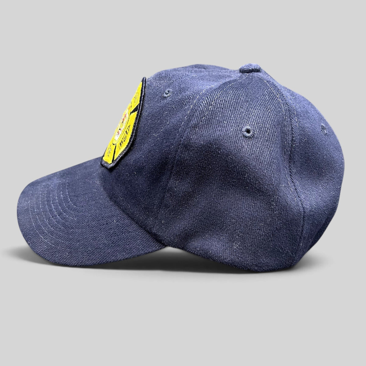 Raree Finds vintage navy blue Nissun strapback hat with an embroidered Honolulu Fire Department maltese cross patch.