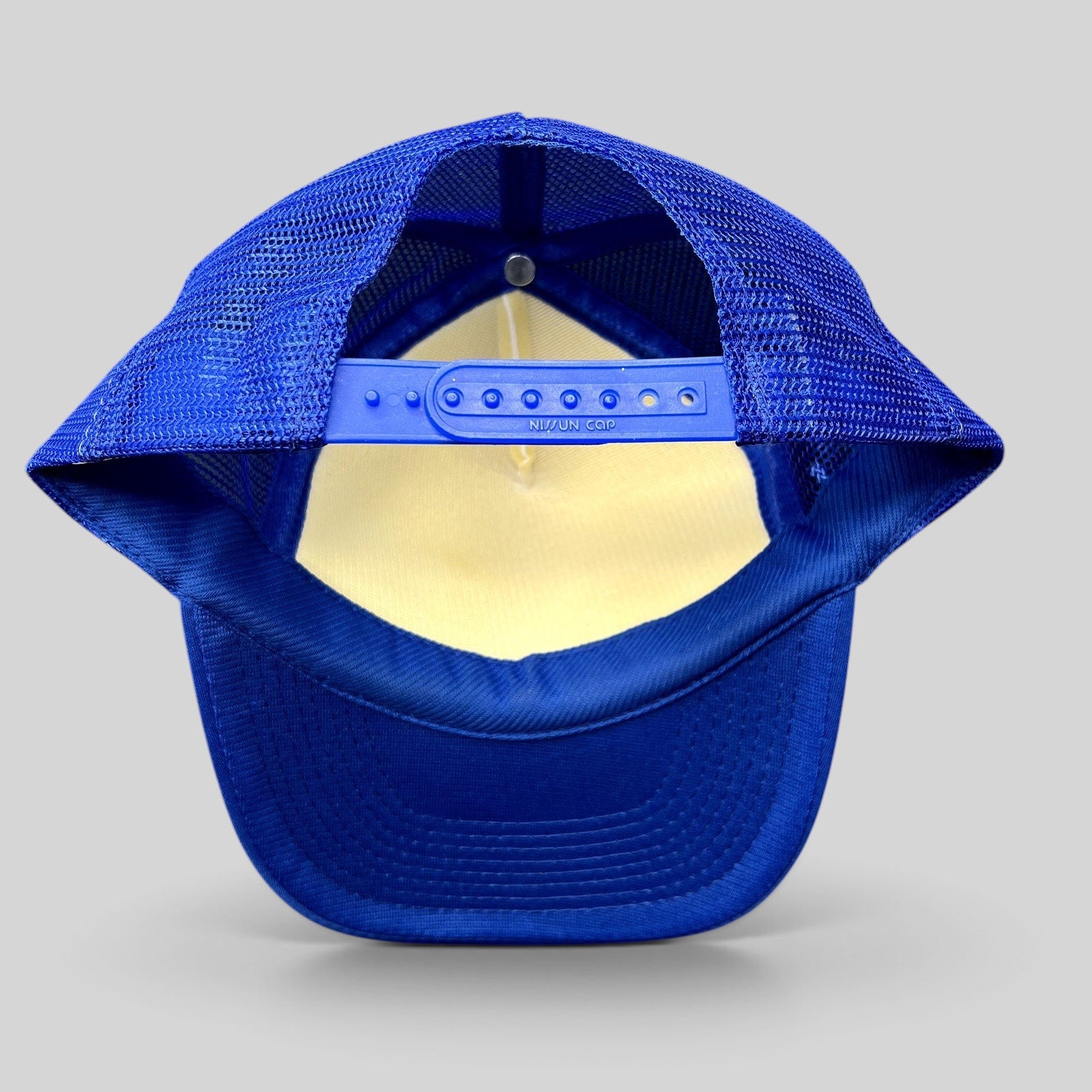 Raree Finds vintage 1983 Honolulu Marathon trucker hat showing the blue mesh back and adjustable plastic snapback strap