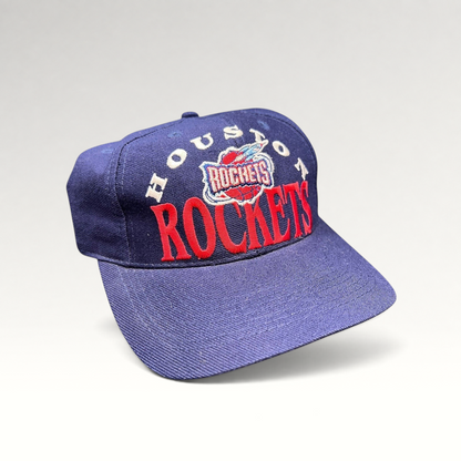 Raree Finds vintage 1990s Houston Rockets snapback hat in navy blue with red embroidered logo and green undervisor