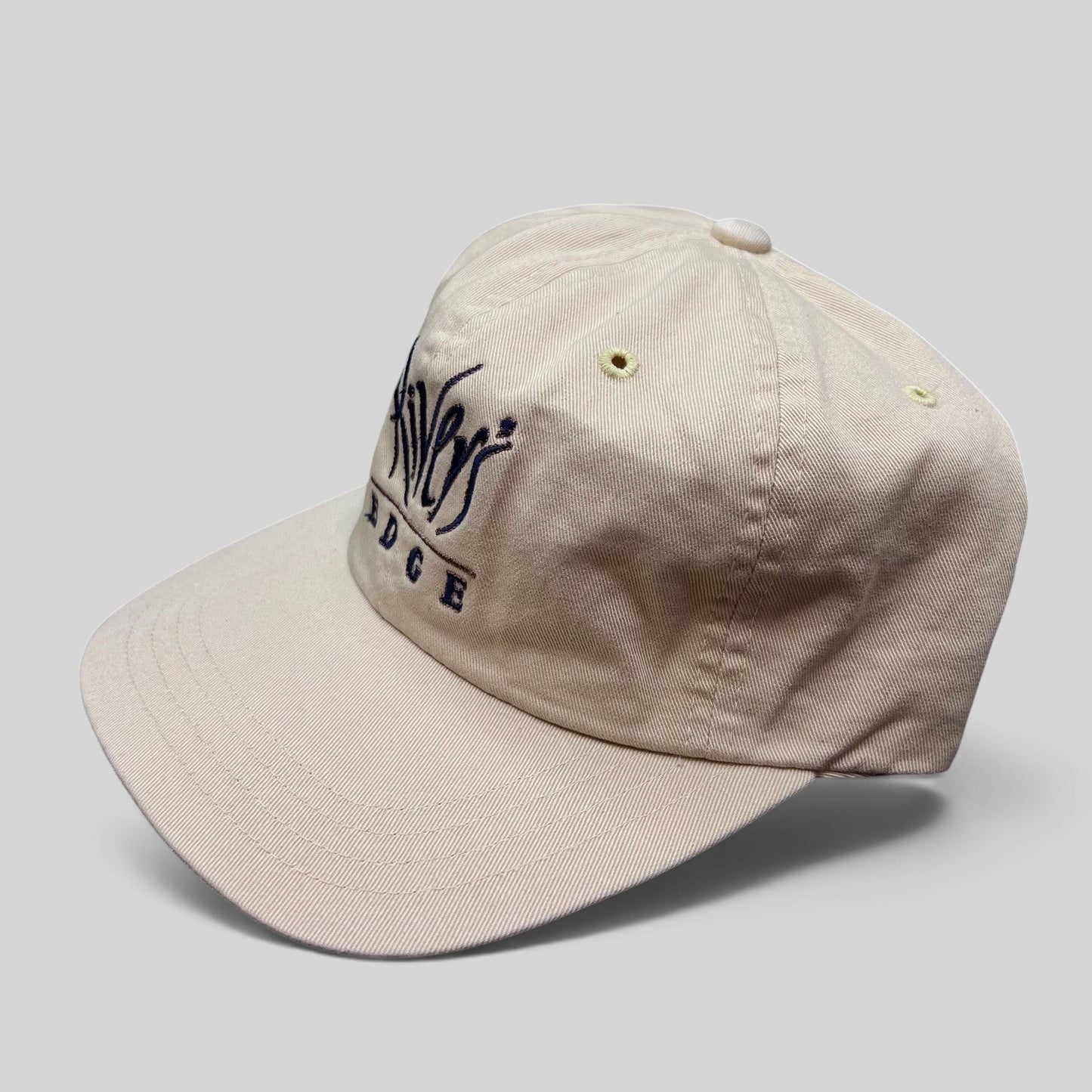Raree Finds vintage Imperial Rivers Edge cream golf strapback hat with embroidered script logo and metal pin detail.